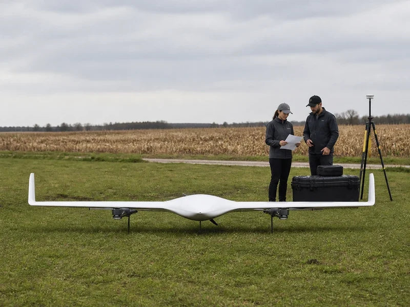 UG21 VTOL aircraft at a mapping site while professionals compare verified platform facts