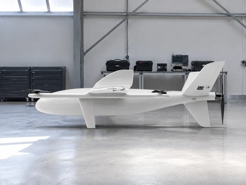 Side profile of complete UG35 in a spacious civilian sensor evaluation workshop with closed instrument cases.