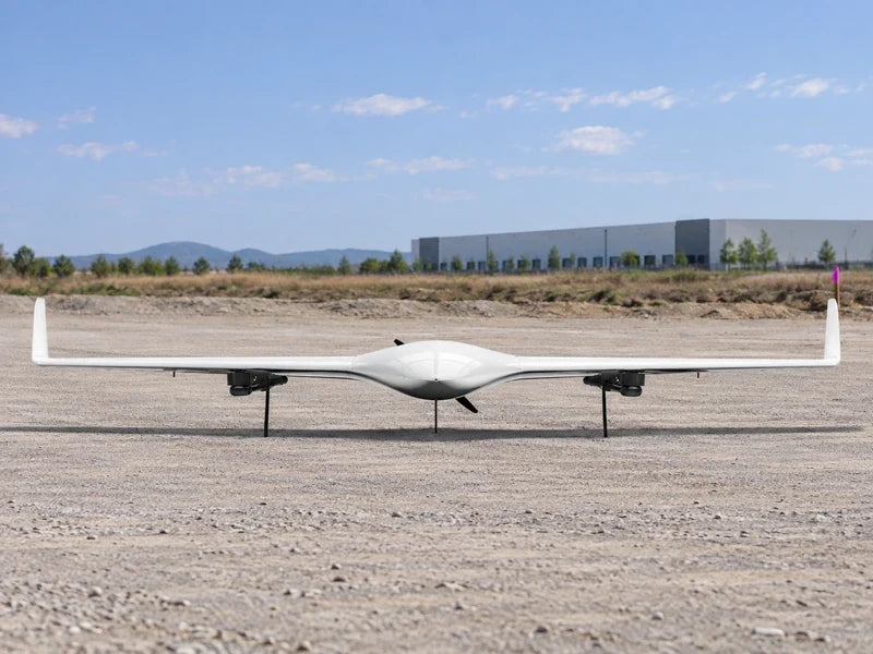 UG21 on a level survey staging strip with an undeveloped parcel and distant warehouse