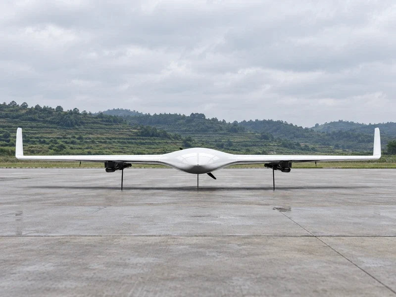 UG21 in its front view on a level survey staging apron with low terraced terrain far behind