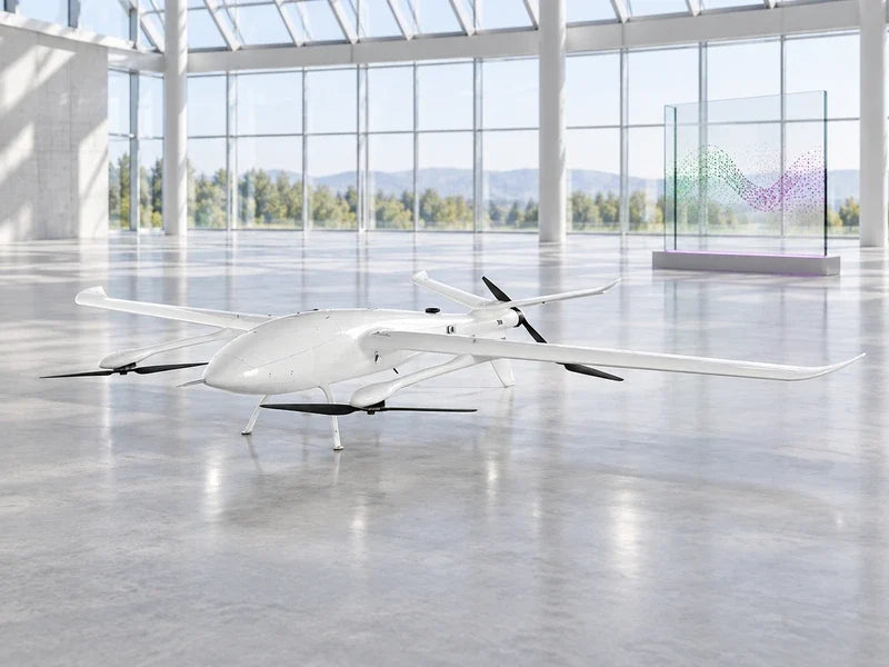 UG39 in its approved elevated front-left view on a broad neutral equipment review floor, separate glass display of colored survey points behind it