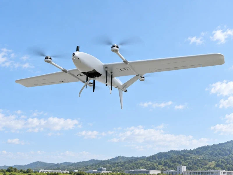 UIV2200 in its approved underbelly three-quarter perspective, airborne above distant campus buildings and green hills