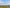 UG25 in the same side profile as its reference above open mottled wet meadow with a distant low horizon, broad soft daylight and generous wing clearance.