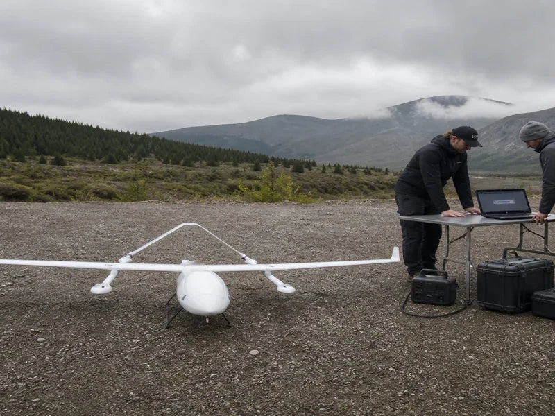 Complete UG62 aircraft beside a rugged field data offload and validation station