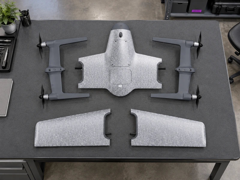 UVH-PNP five genuine reference components in a near-overhead view on one padded costing-studio workbench