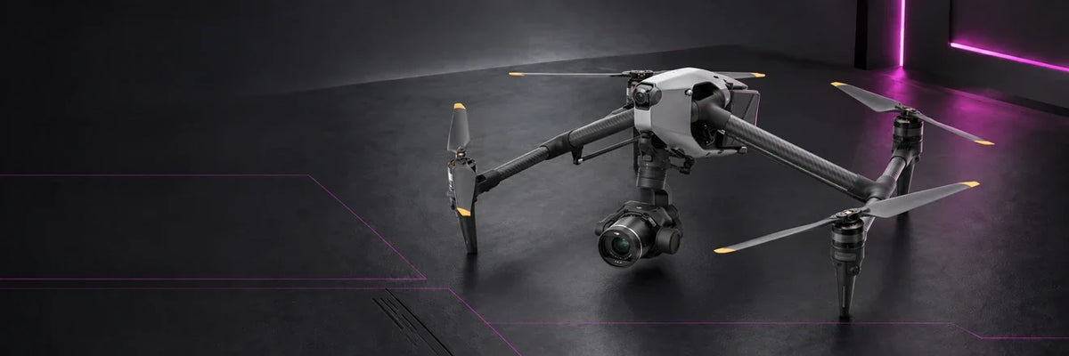 DJI Inspire 3 cinema drone with a suspended gimbal camera in a dark studio with magenta accents.