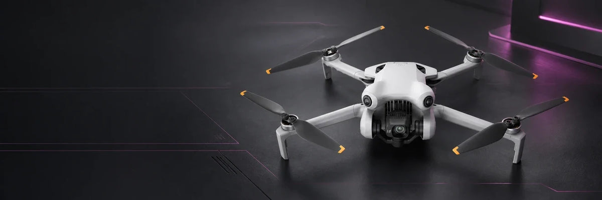 DJI Mini 4 Pro camera drone on a dark graphite background with magenta accents, representing the DJI Mini series.
