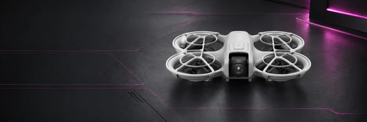 DJI Neo compact camera drone with full-coverage propeller guards on a charcoal studio background with magenta accents